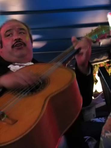 A mariachi strums his guitarrón mexicano at la Fogata in San Antonio, TX